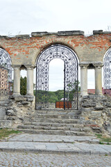 Old forged gates near the church in Kamenets-Podolsk. Ukraine. Historical fence