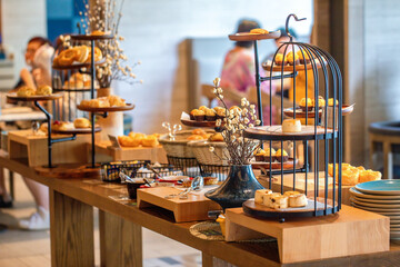 Assorted pastries on display in modern bakery shop. Gourmet and culinary art.