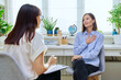 Young woman at mental therapy, talking to female psychologist
