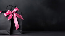 Black Paper Shopping Bag With Pink Bow Gift Ribbon Isolated On Black Background With Copy Space, Banner Template Sale, Discount Day, Shopping Friday Time.