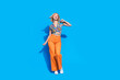 © deagreez - Full length photo of gorgeous woman dressed print blouse orange pants enjoy party dancing isolated on bright blue color background