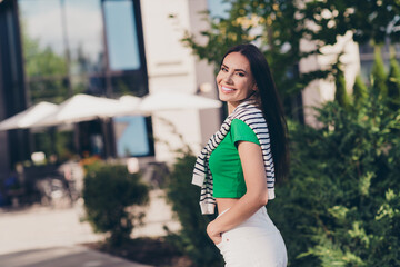 Sticker - Photo of positive shiny girl dressed green top enjoying sunshine walking cafe outdoors urban town park