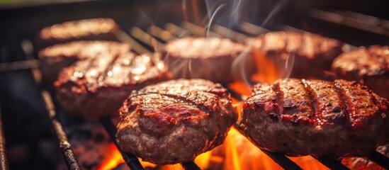 Poster - Juicy beef hamburger patties sizzling over hot flames on the barbecue. Website header. Creative Banner. Copyspace image