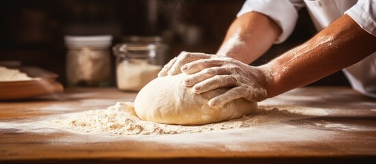 Poster - Man preparing bread dough on wooden table in a bakery close up. Website header. Creative Banner. Copyspace image