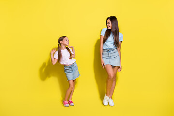 Wall Mural - Photo of two cute girls sisters on family meeting events dancing isolated over shine color background