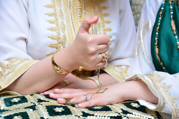 Wall Mural - Woman with Moroccan henna painted hand.