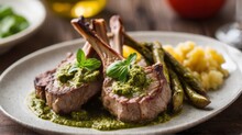 Ribs, Lamb Chops, Steak, Blurred Background Cooked With Pesto Sauce And Herbs On A Round White Plate. It's A Special Meal. Cooked With Side Dishes. Deliciousness And Perfect Taste