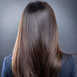 © Mariusz Blach - Back view of woman with long hair in front of brown wall background