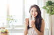 © เลิศลักษณ์ ทิพชัย - Young healthy Asian woman enjoying a fresh fruit smoothie at home. Radiates happiness and vitality