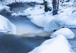 Natural stream in the forest in winter 