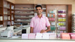 © Aqsapics - Young indian small business owner standing at his own shop