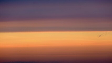Wall Mural - Sunset sky background, time lapse. Beautiful sunset sky with orange and purple colors.