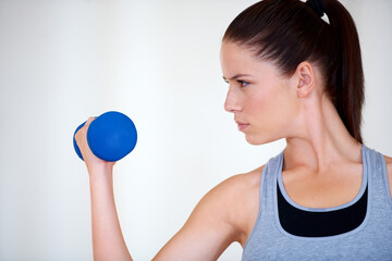 Poster - Woman, training and serious with dumbbells in studio for health wellness, fitness and weight loss with exercise. Young person, commitment and face by hand weights for tone muscle by white background