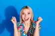 Photo of ecstatic woman with bob hairdo dressed print blouse clenching fists win lottery yell isolated on bright blue color background