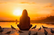 Woman praying and free bird enjoying nature on sunset background, hope concept. Yoga, meditation, nature, zen, mindfulness, praying.