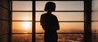 Silhouette of a girl on a balcony overlooking the sunset over the city