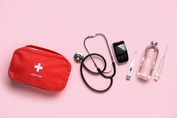 Wall Mural - First aid kit on pink background