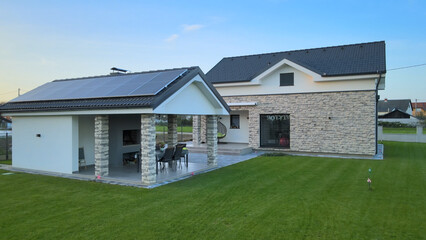 Wall Mural - Aerial view of a suburban house, smart home powered by photovoltaic solar cells