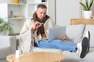 Poster - Ill mature man showing thermometer to doctor online at home