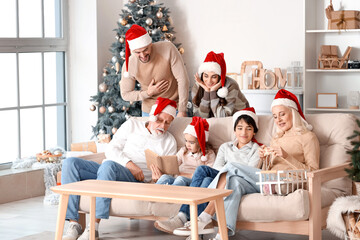 Wall Mural - Big family in Santa hats at home on Christmas eve