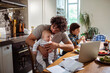 © Marko Geber - Busy Father Multitasking with Work and Children at Home