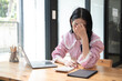 Businesswomen are serious at work causing headaches and stressed out with documents with a laptop at the office.