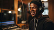 Portrait of a smiling dark-skinned man in a music studio