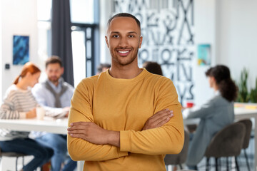 Canvas Print - Team of employees working together in office. Happy man indoors