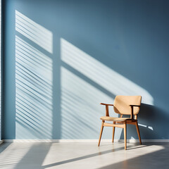 Wooden chair in an empty blue room with light shining through the window