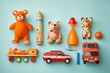 a top vie flat lay background of children's or pet's toys stuffed animals and miniature cars on a pastel blue background