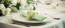 Elegant Indoor Table Setting With Flowery Tablecloth, White Napkin, And Green Placemat For Family Lunch.