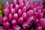 Fototapeta Tulipany - close-up shot of a bouquet of pink tulips in full bloom, exuding the freshness and beauty of spring. The vibrant colors and delicate petals of the flowers are set against a soft, abstract background