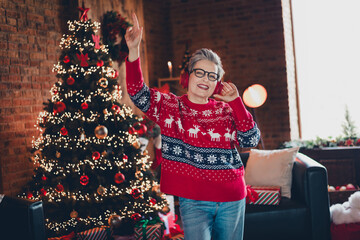 Sticker - Photo of cheerful aged lady dancing enjoy listen christmas music headphones evergreen lights decor house indoors