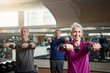 © Grady Reese/peopleimages.com - Training, fitness or senior people with dumbbells at gym for club exercise, wellness or cardio, health or strength. Class, workout or elderly friends at sport studio for bodybuilding or weightlifting
