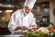 © L.S. - An experienced chef stands in his kitchen and goes through a list of food ingredients to prepare menus.