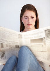 Canvas Print - Relax, living room and a woman reading the newspaper in her home on a weekend for the daily article. Wellness, press or media with a young person in her apartment to research current world events