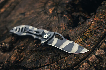 Wall Mural - Folding knife on wooden background. EDC knife.