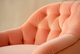 Fototapeta  - The upholstered armchair is a close-up in delicate shades of peach fuzz, the color of the year 2024.