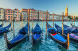Gondolas moored in water of Grand Canal waterway in Venice