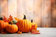Fall background with orange pumpkins and fall leaves on beige background wallpaper