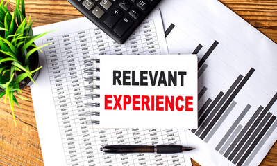 Poster - RELEVANT EXPERIENCE text on a notebook with chart and calculator