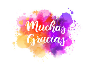 Wall Mural - Muchas gracias - Thank you very much in Spanish. Handwritten modern calligraphy lettering text on abstract watercolor paint splash background.