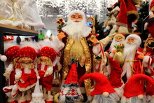 Santa Clause And Christmas Dolls Near Christmas Tree, On Store Window. Beautiful Favorite Toys For New Year. Christmas Winter Shop Shopping