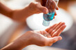 © Marko Geber - Close up woman using antibacterial hand sanitizer
