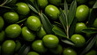 Fresh green olives group with olive tree leaves and glistening droplets of water. Shot top down view. Healthy and beautiful mediterranean food photography for a magazine and commercial advertising