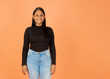 © Nataly - latin girl smiling from front on orange background