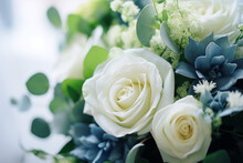 A Stunning Floral Arrangement Of White Roses And Blue Succulents, Offering A Serene Blend Of Color And Texture For A Sophisticated Decor.