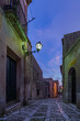 A characteristic alley of the Erice medieval town at nightfall, Sicily 