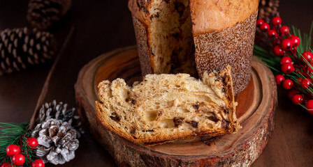 Wall Mural - Slice of delicious Panettone with chocolate for Christmas. On wooden table