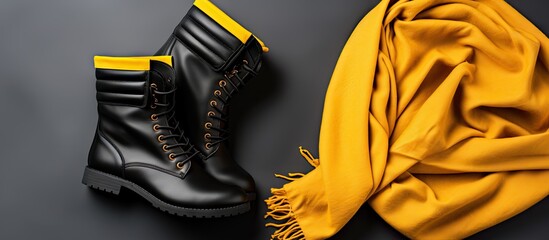 Aufkleber - Women fashionable black leather ankle boots on mustard scarf Flat lay top view. Copyspace image. Header for website template